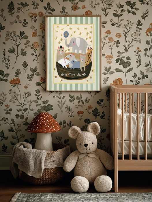 Framed Adventure Awaits animal nursery print on botanical wallpaper beside a cot, teddy bear and mushroom lamp