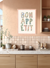 Pastel floral Bon Appetit wall art in blue, pink, coral and sage above a dining table