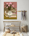 Tabby cat asleep on a stack of books, still life art print shown in a styled room