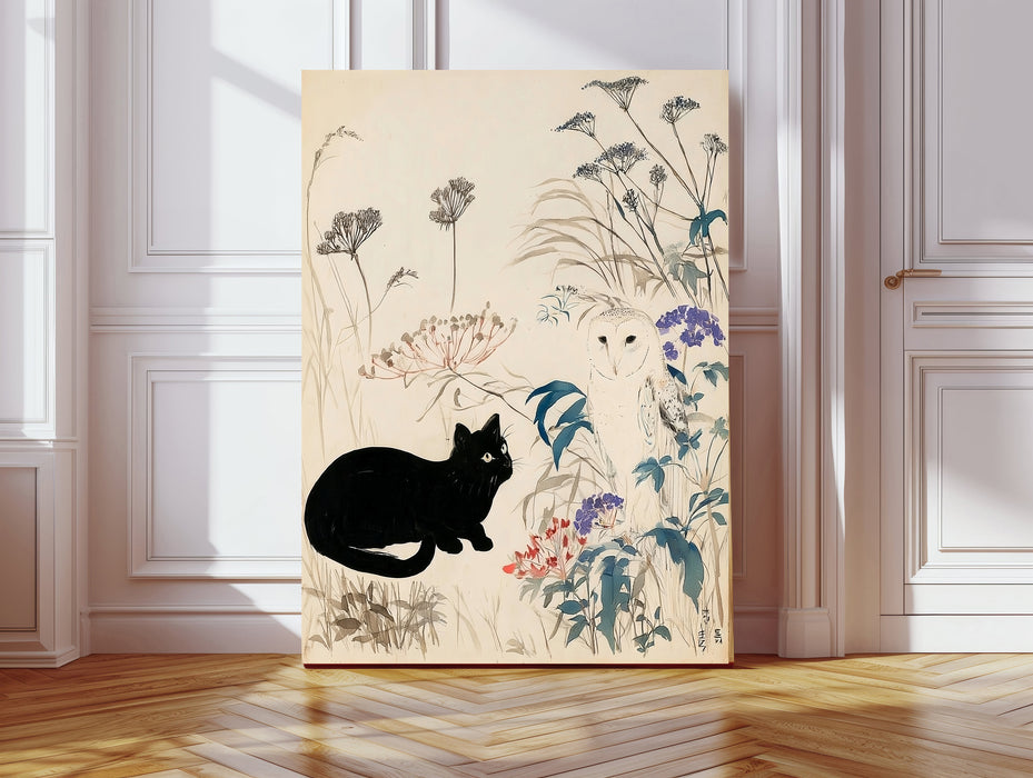 Japanese style print of a black cat watching a white barn owl among ink-drawn wildflowers, on a large canvas leaning against a white panelled wall