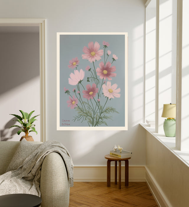 Cosmos October birth flower print hanging in a sunlit living room above a linen armchair with side table and plant