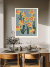 Daffodil March birth flower print above a wooden dining table with olive branches and stoneware