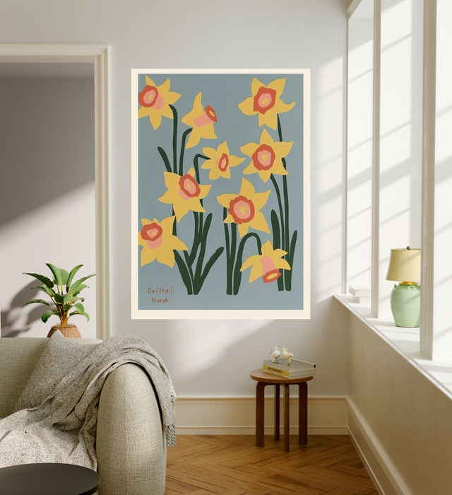 Daffodil botanical art print hanging in a sunlit living room above a linen armchair with side table and plant