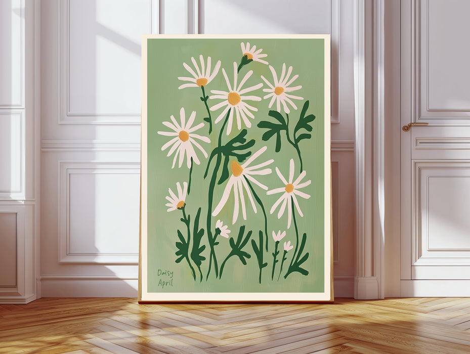 Daisy April birth flower print resting on a wicker chest beside a bed and olive tree in a neutral bedroom