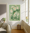 April birth flower art print of white daisies on sage green in a gold frame, Daisy April lettering, leaning against a panelled wall