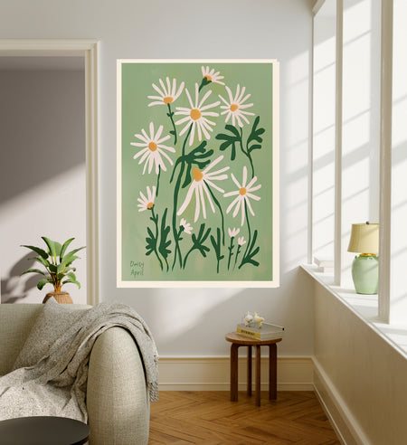 April birth flower art print of white daisies on sage green in a gold frame, Daisy April lettering, leaning against a panelled wall