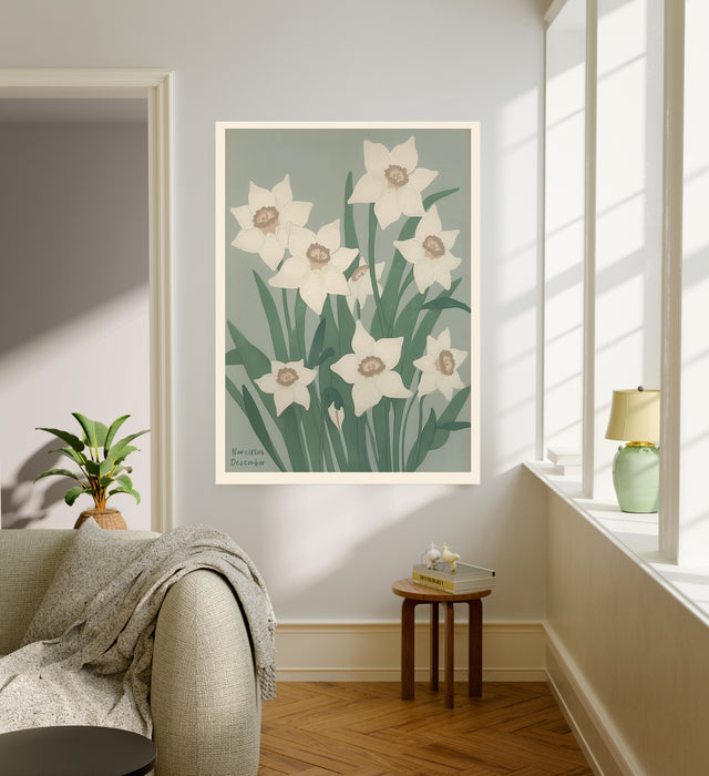 December birth flower art print of white narcissus on sage green in a gold frame, Narcissus December lettering, leaning against a panelled wall