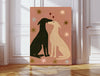 Greyhound love art print, black and cream sighthounds kissing under red hearts and stars on dusty pink, leaning against a panelled wall