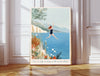 Wild swimming art print in a gold frame with the quote Fear is only as deep as the mind allows, woman jumping into a blue lake with wildflowers and mountains