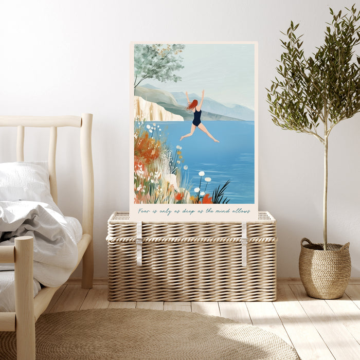 Wild swimming art print resting on a wicker chest beside a bed and olive tree in a calm neutral bedroom
