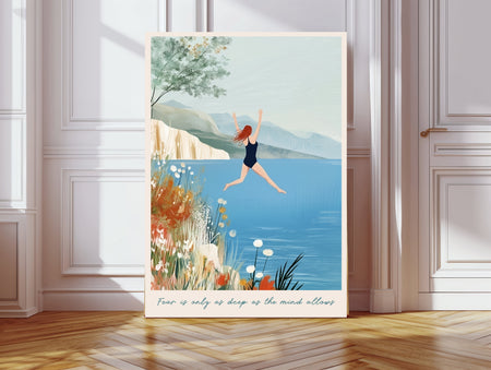 Wild swimming art print of a woman jumping into a blue lake with wildflowers and mountains, with the quote fear is only as deep as the mind allows