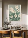 Narcissus botanical birth flower print above a wooden dining table with olive branches and stoneware