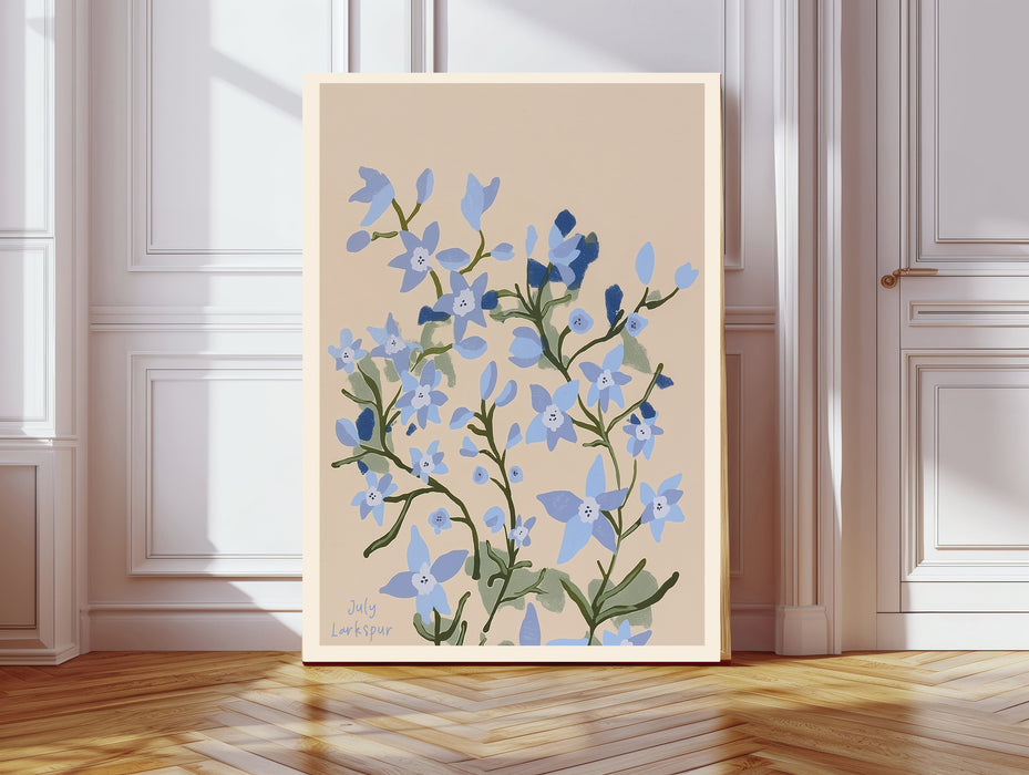 Larkspur botanical birth flower print resting on a wicker chest beside a bed and olive tree in a neutral bedroom