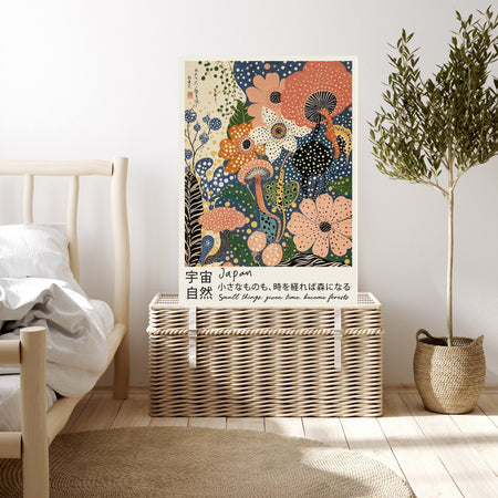 Peach and blue Japanese floral quote art print resting on a wicker chest beside a bed and olive tree in a neutral bedroom