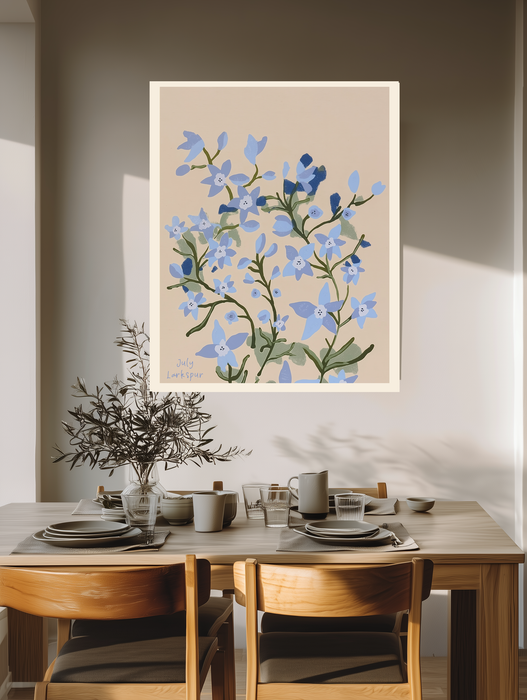 Blue larkspur birth month flower print above a wooden dining table with olive branches and stoneware
