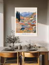 Japanese mountain garden quote art print above a wooden dining table with olive branches and stoneware