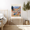 Colourful Japanese landscape art print resting on a wicker chest beside a bed and olive tree in a neutral bedroom