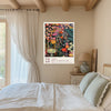 Midnight wildflower botanical art print on a beamed bedroom wall with linen curtains and sage green bedding