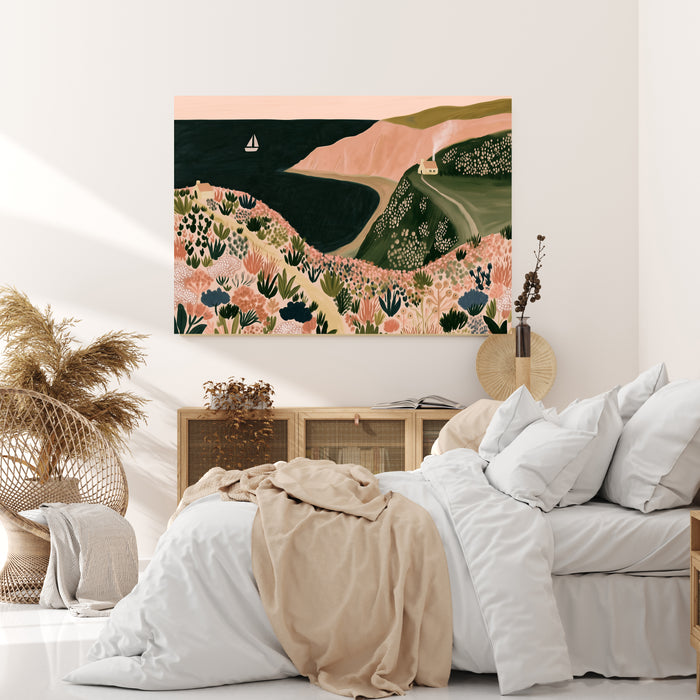 Pink cliffs coastal landscape art print with a dark sea, sailboat and wildflower clifftop path, leaning against a white panelled wall