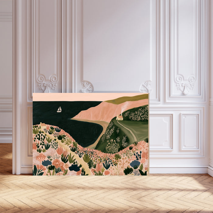 Blush pink and sage green seaside wall art with clifftop flowers and a little cottage by the sea