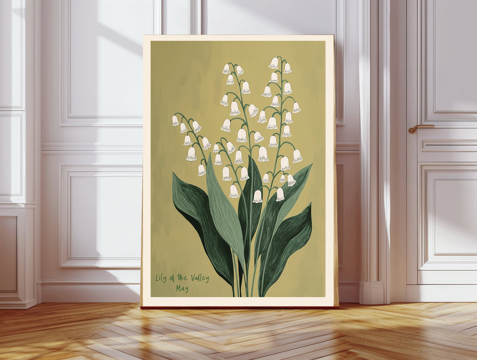 May birth flower art print of lily of the valley on olive green in a gold frame, Lily of the Valley May lettering, leaning against a panelled wall