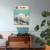 Framed Japanese snow mountain print above a mid century sideboard with record player and monstera plant