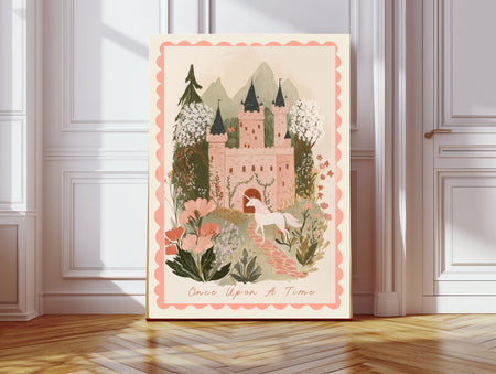 Once Upon A Time pink fairytale castle and unicorn nursery print with scalloped border, leaning against a white panelled wall