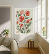 Poppy August birth flower print hanging in a sunlit living room above a linen armchair with side table and plant