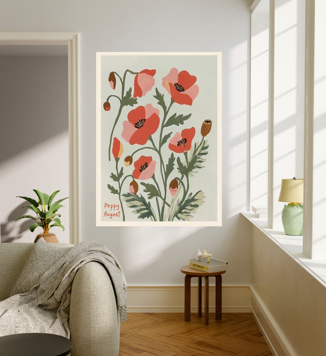 Poppy August birth flower print hanging in a sunlit living room above a linen armchair with side table and plant