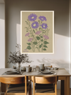 Aster botanical birth flower print above a wooden dining table with olive branches and stoneware