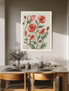 Poppy birth flower botanical print above a wooden dining table with olive branches and stoneware