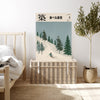 Japanese skiing landscape print resting on a rattan trunk in a neutral bedroom with olive tree