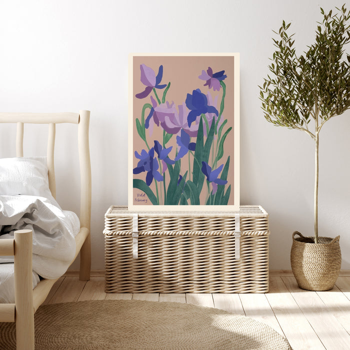 February violet birth flower print resting on a wicker chest beside a bed and olive tree in a neutral bedroom